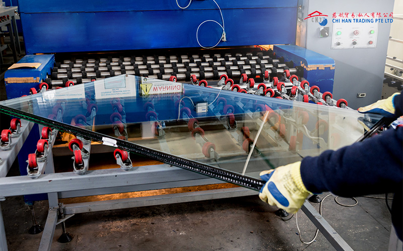Workers processing glass for construction.