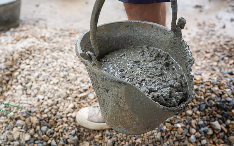 Bucket containing fresh wet concrete mix.