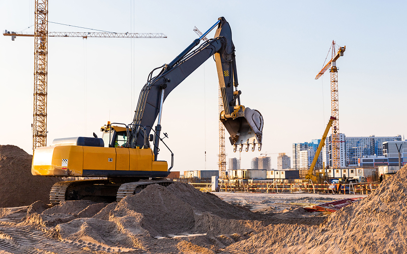 Yellow-hydraulic-excavator-at-busy-construction-site.